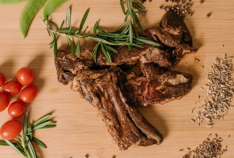 Bifes de cordeiro em uma tabua de madeira