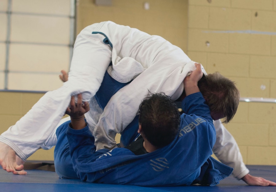 Dois homens lutando jiu jitsu