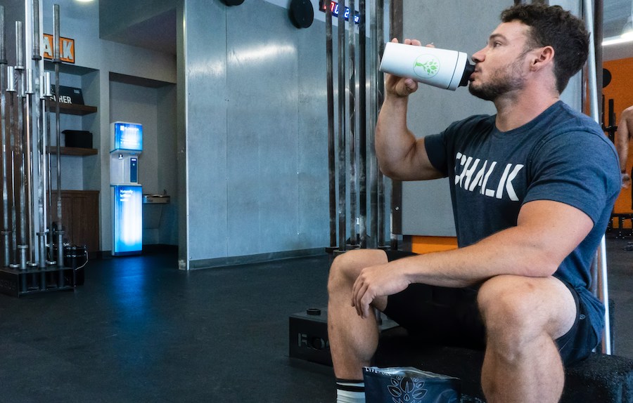 Homem tomando shake de creatina, whey e bcaa na academia